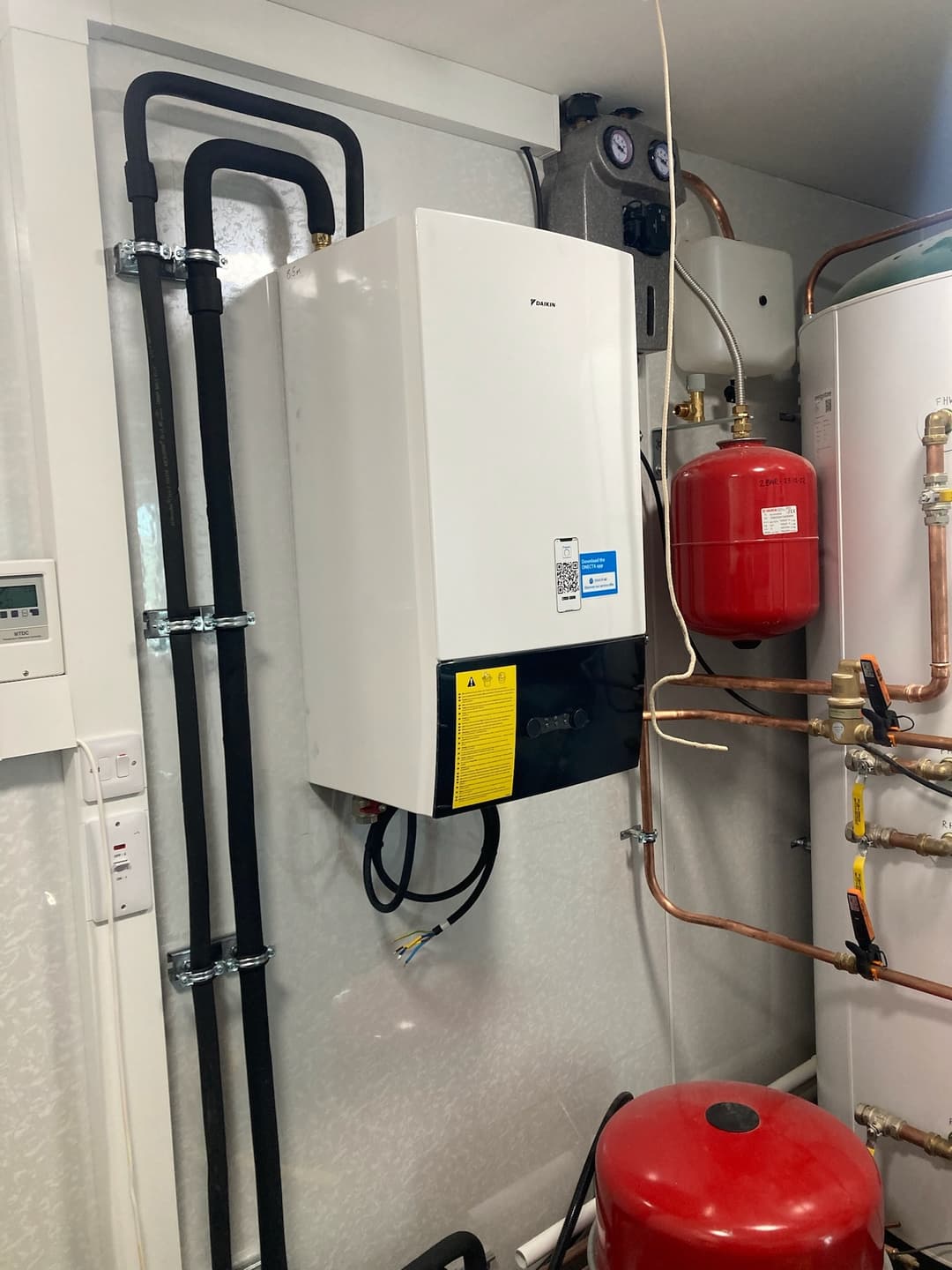 Boiler and expansion vessel with tidy copper pipework