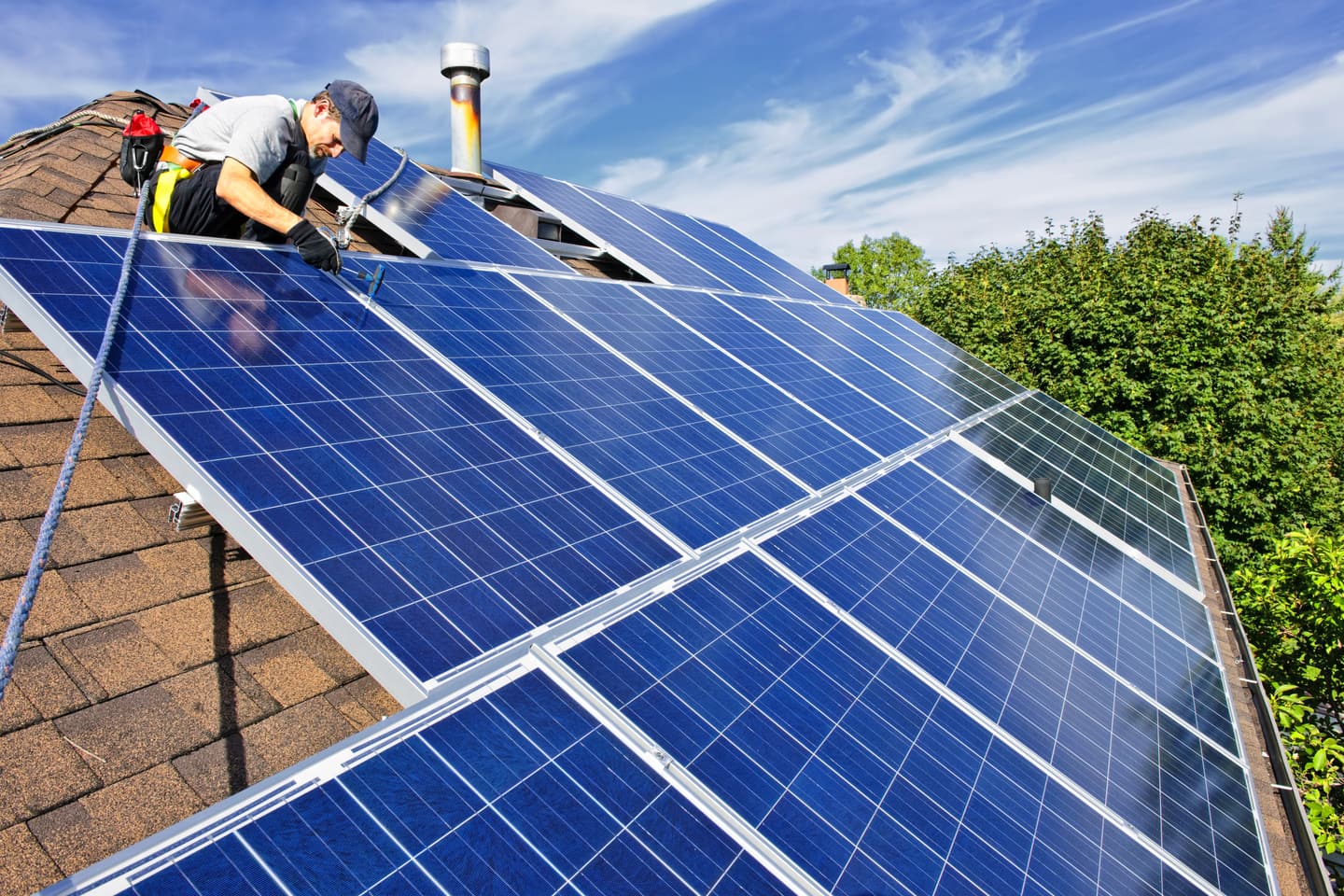 Solar panels installed on a roof against a blue sky